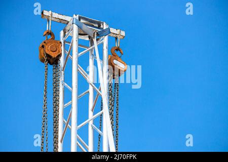 manual hoist pully wheel with metal chain at tower for lift heavy stage light structure in concert exhibition area Stock Photo