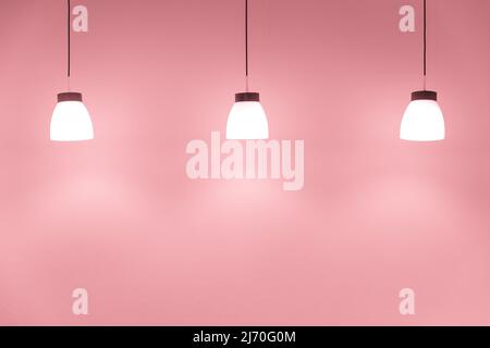 ceiling drop down light decoration on sweet pink wall for interior lighting background Stock Photo