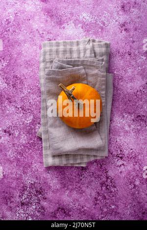 Linen napkin on lilac concrete background Stock Photo