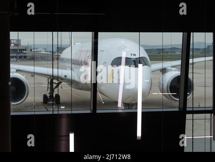 05 May 2022, Hessen, Frankfurt/Main: A passenger aircraft stands in front of Pier G at Terminal 3 of Frankfurt Airport. Photo: Boris Roessler/dpa Stock Photo