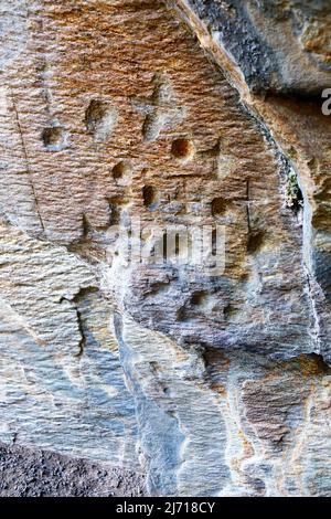 Early Christian carvings and possible bronze cup markings in Scoor Cave on the Isle of Mull Stock Photo