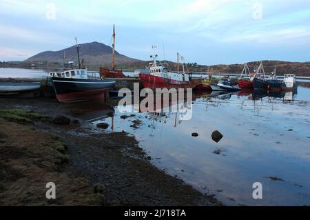 Fishing boats docked at a pier in Connemara County Galway west of Ireland. Stock Photo