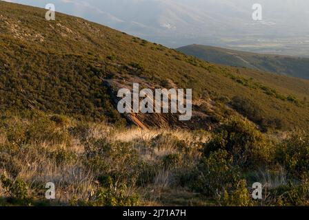 Sale of slate , old orange red slate stone extraction mine on mountain slope Stock Photo