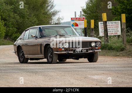 1969 British Jensen Interceptor Mk 1 6.3-litre CGT 5H pulling away from a Tank crossing on Salisbury plain Stock Photo