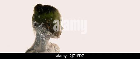 Conceptual image. Transparent silhouette of young tender woman and water splashes around grass isolated over grey background Stock Photo
