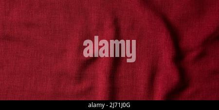 Red crumpled linen fabric texture background. Natural linen organic eco textiles canvas background. Top view Stock Photo