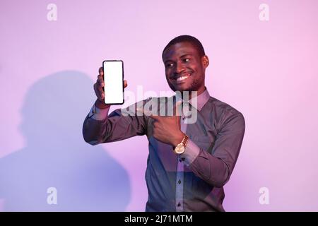 excited african man showing his phone screen Stock Photo