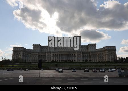 Dark clouds above House of the People  in Bucharest, Romania, which is the 2nd largest building in the world; seat of  Romanian parliament; conceptual Stock Photo