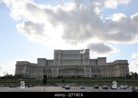 Dark clouds above House of the People  in Bucharest, Romania, which is the 2nd largest building in the world; seat of  Romanian parliament; conceptual Stock Photo