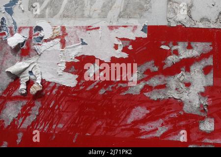 Torn paper stickers and stains on weathered grunge background. Stock Photo