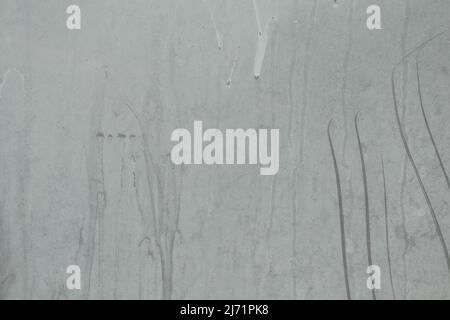Painted white dirty glass surface with dust and scratches. Grunge background with copy space. Stock Photo