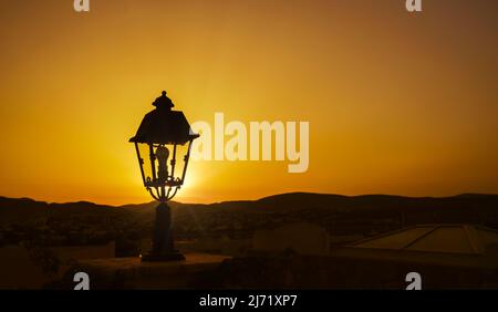 Street lamp against the backdrop of a golden sunset Stock Photo