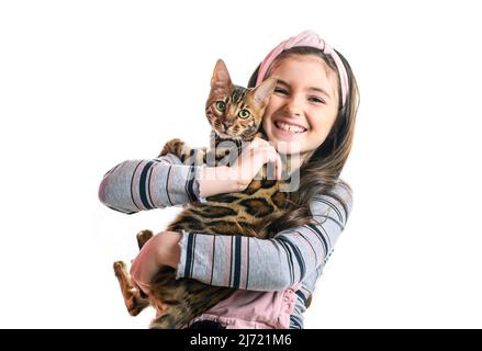 little girl holding bengal cat isolated on white background Stock Photo