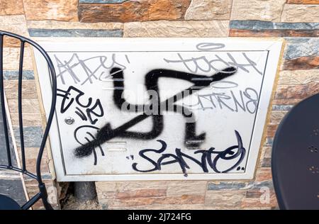 Crossed out svastika sign - graffiti on the wall in Seville, Andalucia, Spain. Antifa graffiti swastika swastikas nazi symbols crossed Stock Photo