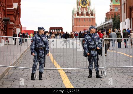 Soldiers of russian military forces of National Guard standing near the fencing on Red Square on Kremlin tower background Stock Photo