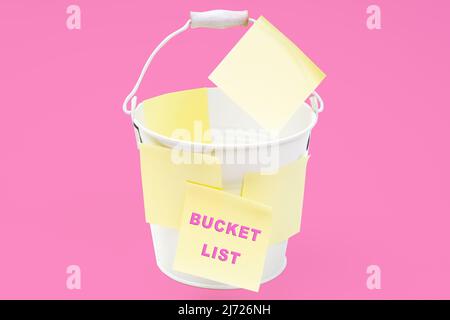 Small steel bucket covered with note stickers reading BUCKET LIST isolated on pink background. Stock Photo