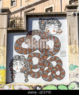 The mural with snakes on wall in Lavapiez, Madrid featuring abstract mural work by artist Sarah Fratini. Muros Tabacalera 2019 theme - Chance Stock Photo
