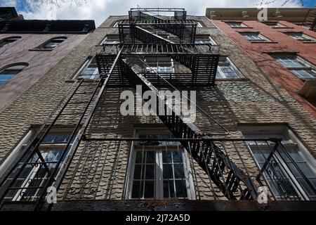 Typical exterior wrought-iron fire escape in New York City Stock Photo ...