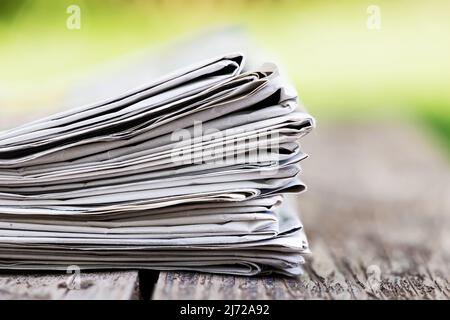 Daily news or journalist concept background, newspapers on an old wooden table Stock Photo