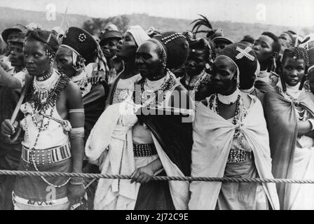 Zulus Greet Royal Family -- The Royal Family had their first view of Zulus when they were greeted by these bead-bedecked women at Waggon Bridge, Ladysmith, on the occasion of crossing the border from the Orange Free State into Natal. Their Majesties were welcomed at Ladysmith by General Smuts and nearly 3,000 South African Indians, the whole Indian population of Ladysmith. March 18, 1947. Stock Photo