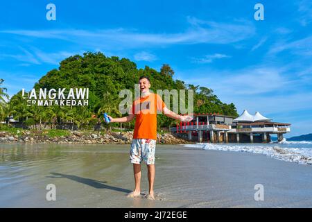 happy tourist guy on the central beach in Langkawi tropical island. Stock Photo