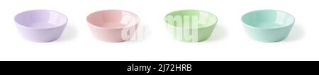 Colorful ceramic bowls isolated on a white background. Set of multicolored porcelain ramekins cutout. Pastel colored empty crockery for food design. Stock Photo