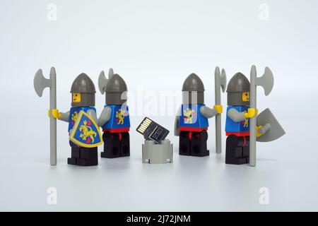 44MP size HRS. Data security concept using Lego mini figure knights & a micro SD card. Stock Photo