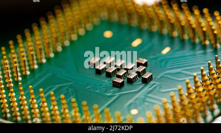 Macro Close up of microchips and pins on Main CPU PC processor circuit board. Stock Photo