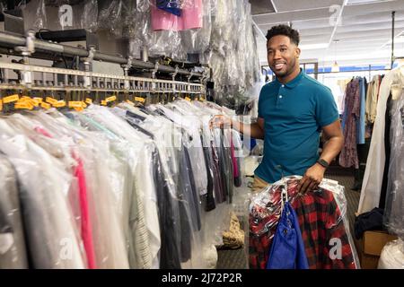 young smiling african american cleaners with cleaning equipment working  together Stock Photo - Alamy