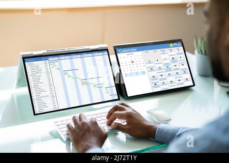 Scheduling Plan Using Cloud Software On Laptop Stock Photo