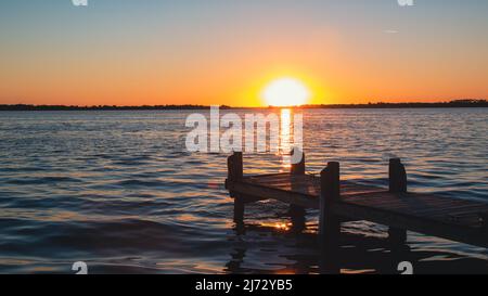 Blue orange sunset on Lake Dora dock in Mount Dora Florida Stock Photo