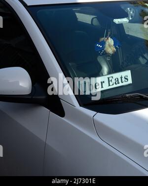 An Uber Eats car and driver making a delivery in San Francisco, California. Stock Photo