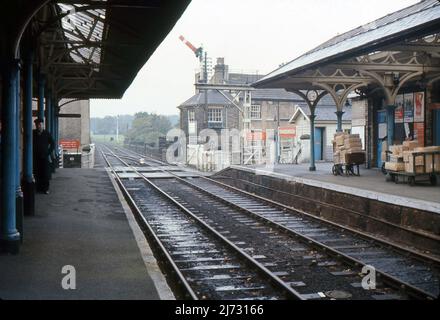 A view from the platform of Knaresborough railway station, North Yorkshire. 1967. Parcels stacked on barrows await collection. Stock Photo
