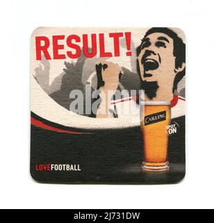 A vintage beer mat produced as a promotional item for Carling lager beer, advertising its sponsorship of the England Football Team, ahead of the UEFA Euro 2004 tournament held in Portugal. It features a pint of lager, a supporter celebrating and the slogans, “Result!”, “Love-Football” and “Spot On”. Stock Photo