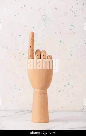 Wooden hand with raised index finger on white background Stock Photo ...