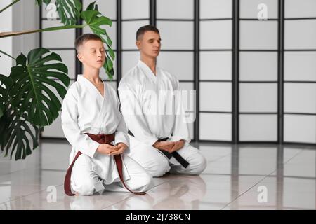 Boy and karate instructor in dojo Stock Photo