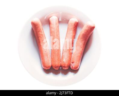 grilled hotdog sausages on white plate Stock Photo