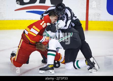 Arizona Coyotes defenseman Josh Brown (3) lands a punch during a fight  against San Jose Sharks center Michael Eyssimont as linesman Devin Berg,  left, looks on during the first period of an