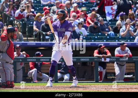 DENVER, CO - May 15: Colorado Rockies first baseman Connor Joe (9) puts a  ball in play and advances the baserunner during a game between the Colorado  Rockies and the Cincinnati Reds