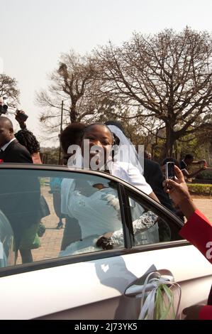 Bride leaving in wedding car, St Michael's and All Angels' Presbyterian Church, Blantyre Mission, Blantyre, Malawi, Africa.  This was the first Christ Stock Photo