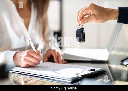 Receiving Car Key From Salesmen. Customer And Owner Stock Photo