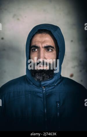 Bearded middle eastern man wearing hooded jacket Stock Photo