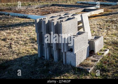 Building blocks on a wooden pallet. Concrete house foundations, construction site. Stock Photo