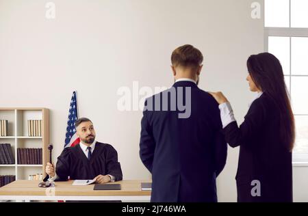 American judge giving judgement and banging gavel after court trial in courtroom Stock Photo