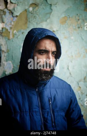 Bearded middle eastern man wearing hooded jacket Stock Photo