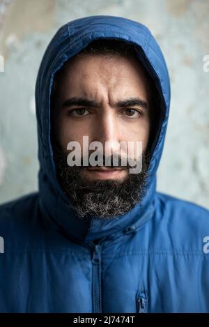 Bearded middle eastern man wearing hooded jacket Stock Photo