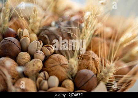 Handmade bouquet of nuts, pine cones, spikelets for holiday. Food floristry. Gift for men. Edible bouquet for birthday, valentine's day. Selective focus. High quality photo Stock Photo