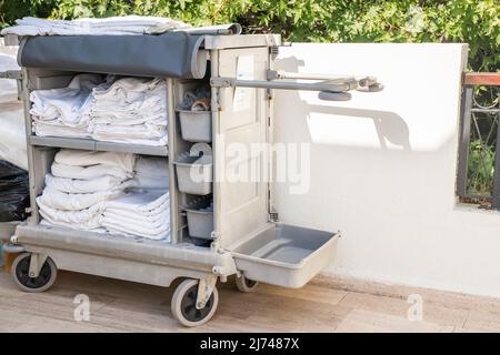 Cleaning trolley with cleaning equipment in outdoor hotel Stock Photo