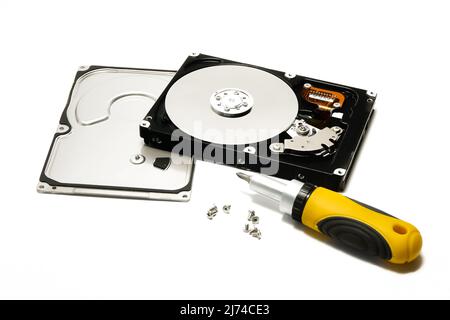 Open hard drive and screwdriver isolated on white background closeup. Computer hard drive HDD. computer memory. Stock Photo