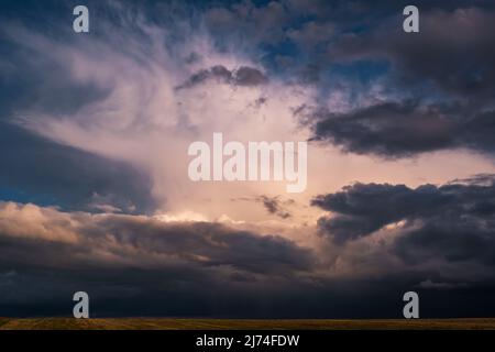 Blue sky background with dark striped clouds before storm. blue sky panorama may use for sky replacement Stock Photo